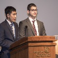 man speaking at podium