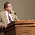 man speaking at podium