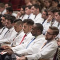 people in white coats seated
