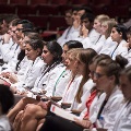 people in white coats seated
