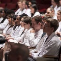 people in white coats seated