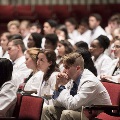 crowd of students wearing white coats