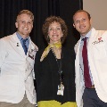 Three people pose for a photo