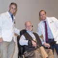 Three people pose for a photo