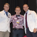 Three people pose for a photo