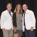 Three people pose for a photo