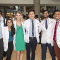 Five students pose for a photo