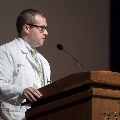 a man speaks at a podium