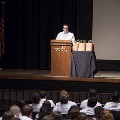 speaker in lab coat at podium