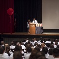 two people in lab coats with crowd